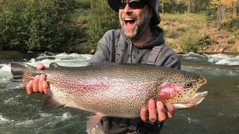 This man is excited to have caught a massive Rainbow Trout