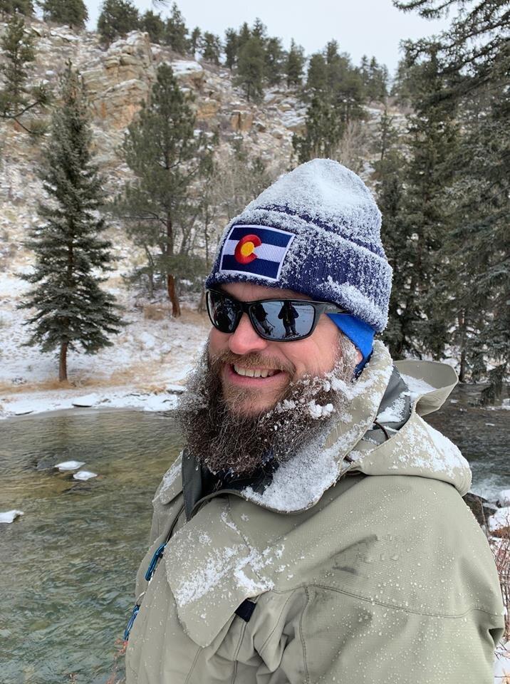 Man wearing a Colorado hat smiles at the camera