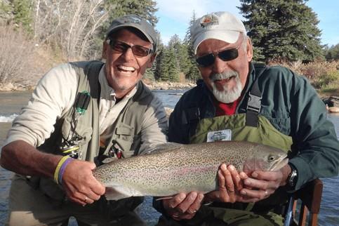 Laughs between friends over a gorgeous Rainbow Trout with North Fork Ranch Guide Service.