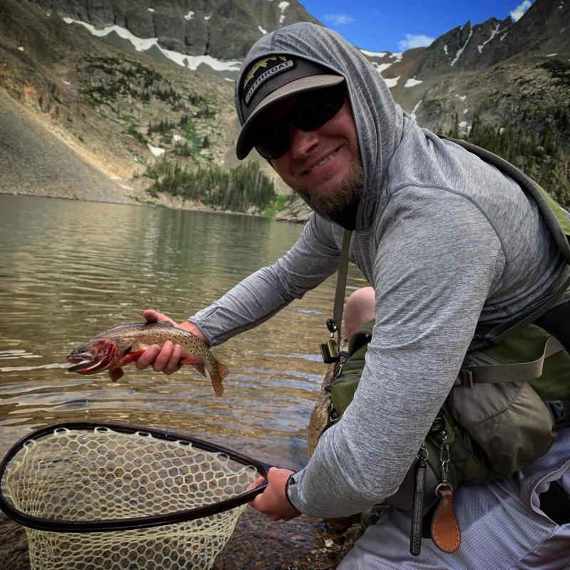 Robert Mahoney holding trout above net